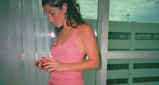 Side view of a woman in a pink chemise.