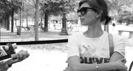 Black and white photo of Nathalie Agussol in sunglasses and a T shirt.
