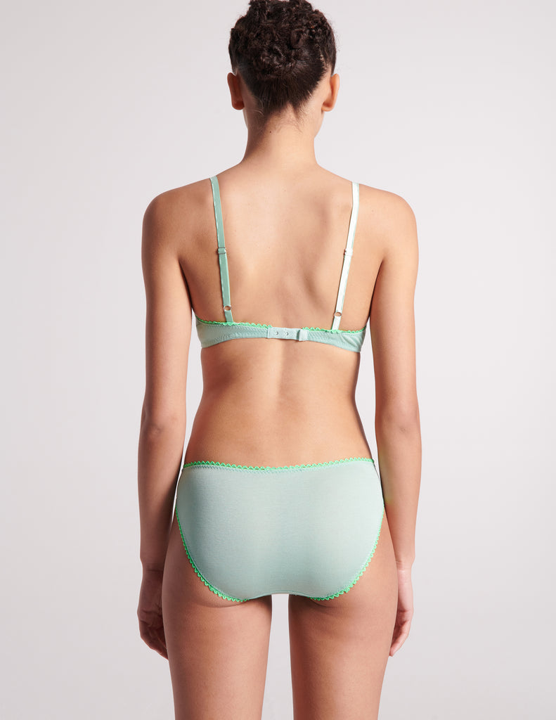 back view of woman in light green bra and panty