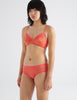 three quarter view of woman in orange cotton bra and hipster 