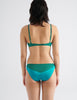 back shot of woman in green silk bra and panty