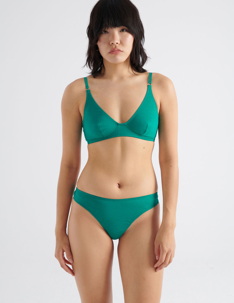 Front view image of model wearing green recycled organic cotton thing and matching bralette