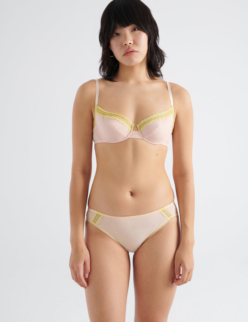 Front image of model wearing peach colored  cotton crepe underwire bra with matching panties. 