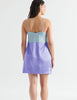 back of woman in light blue and periwinkle silk slip