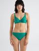 front view image of model wearing green lace underwire bra and panty