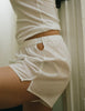 woman wearing white boxer with cutout at waist and white top