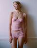 woman in pink lace cami and short