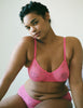 woman wearing stretch pink lace soft cup bra and matching hipster
