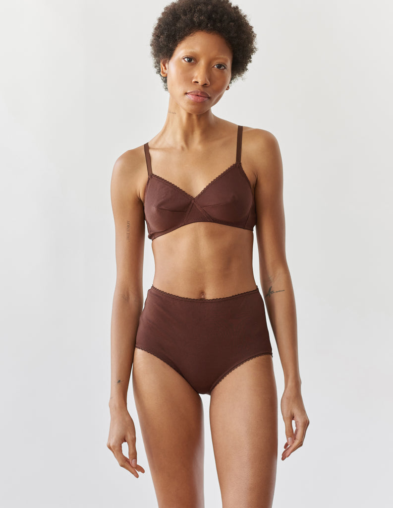 A woman wearing the brown cotton Antonia Bralette and Isabella cotton panty.
