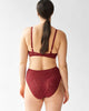 back of woman wearing red lace bra and matching high waist panty by Araks