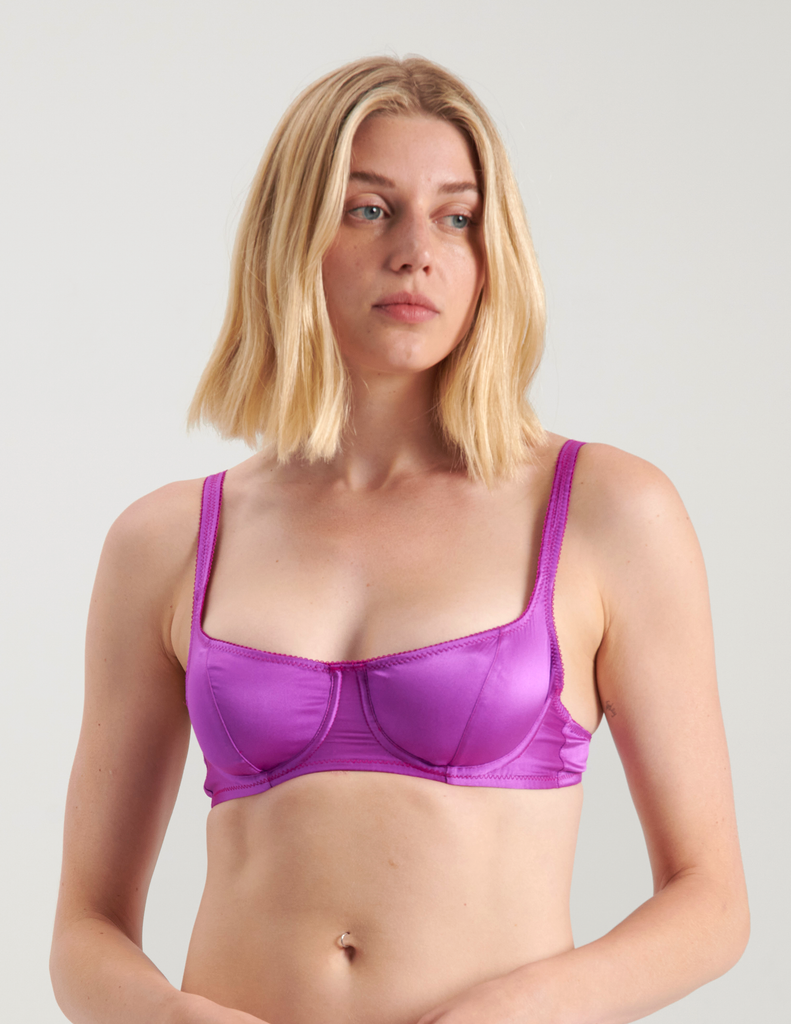 A woman wearing a purple silk underwire bra by Araks