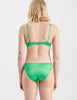 Back of Woman in green silk bra and panty