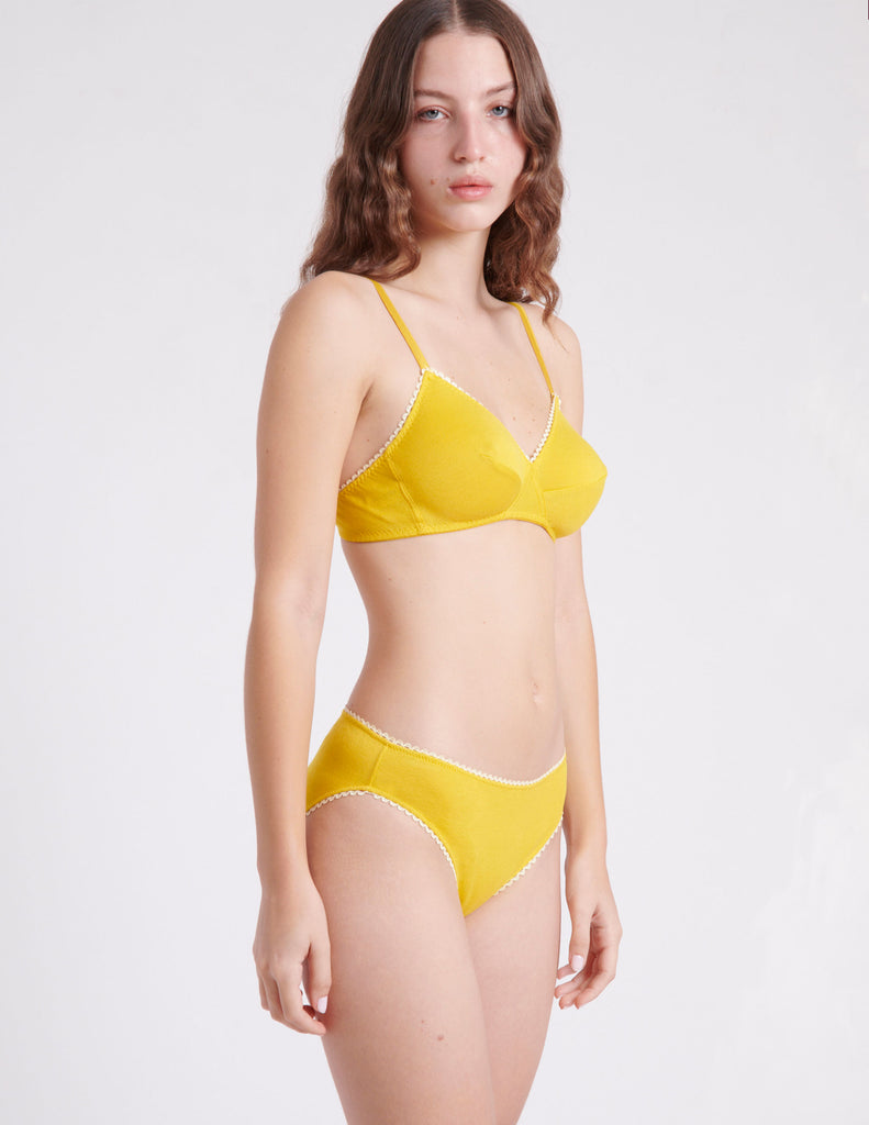 side view of woman in yellow bra and panty 