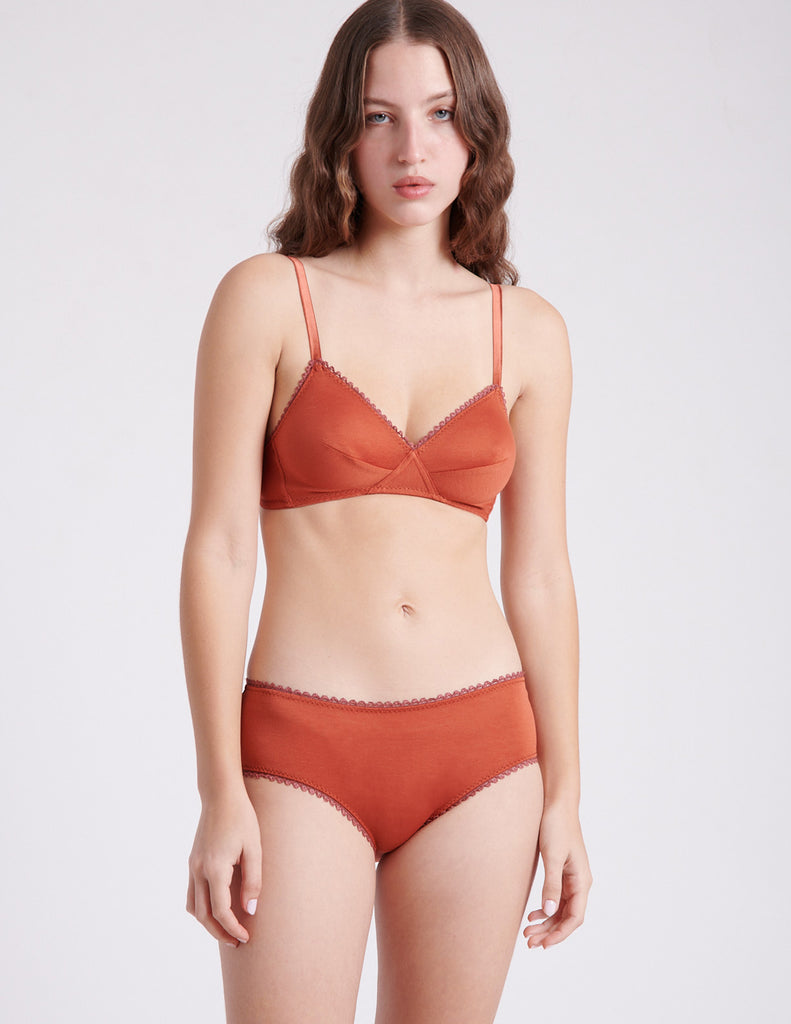 front view of woman in orange bra and panty'
