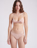 front view of woman in nude silk bra and panty