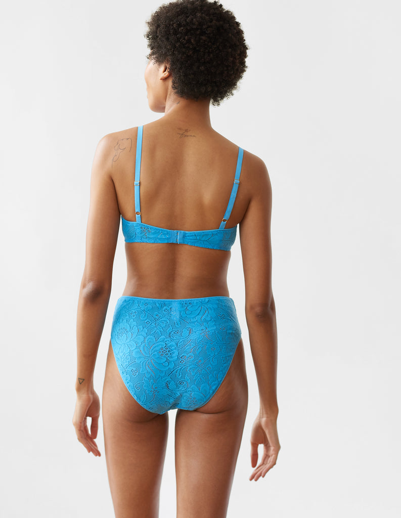 Woman wearing the blue lace Tamara Bralette and Tali  lace panty.