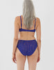 Back view of woman wearing blue lace panty with matching bralette
