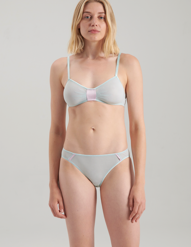 A woman wearing a blue cotton bra with silk insert and matching panties by Araks