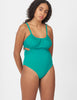 Front view of woman wearing a green one piece swimsuit with side cut outs and a tie in back