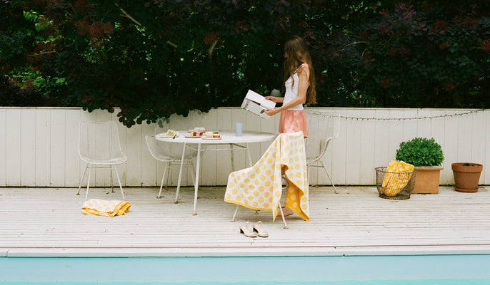 Woman reading by pool