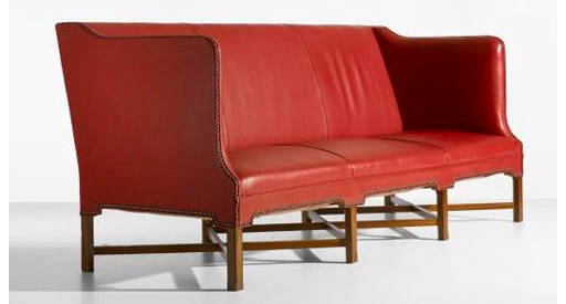 Red leather couch with brown legs.
