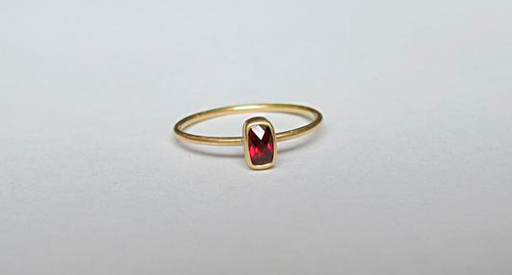 Gold ring with a red stone