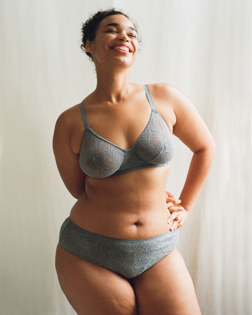 A model wearing the Tamara Bralette and Imogen Hipster in grey stretch lace.