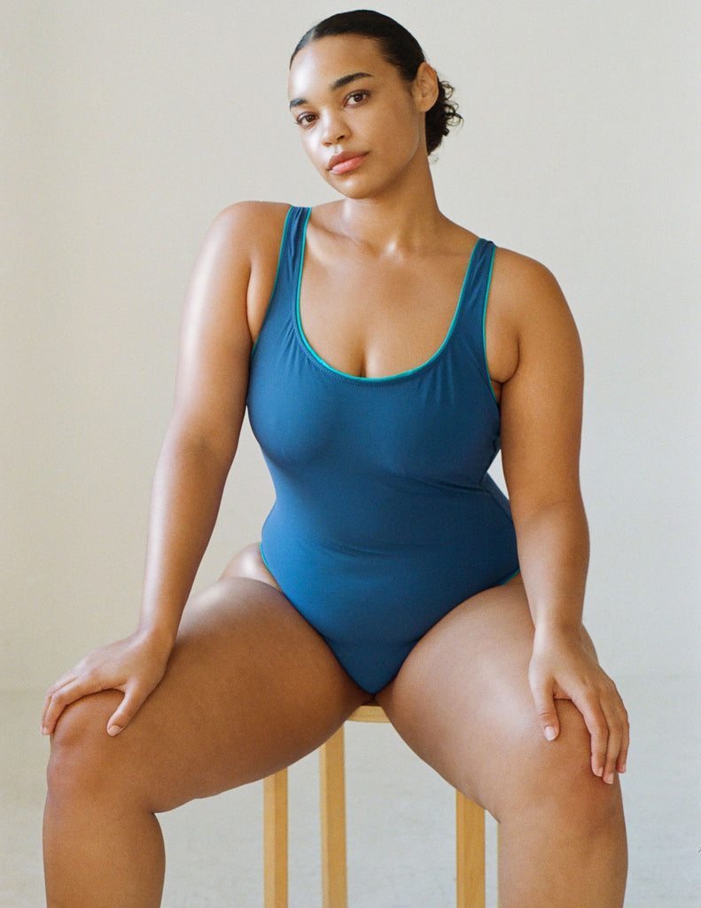 a model wearing the luna one piece swimsuit in dark blue
