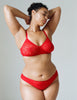 a model wearing the tris panty in ruby red lace.