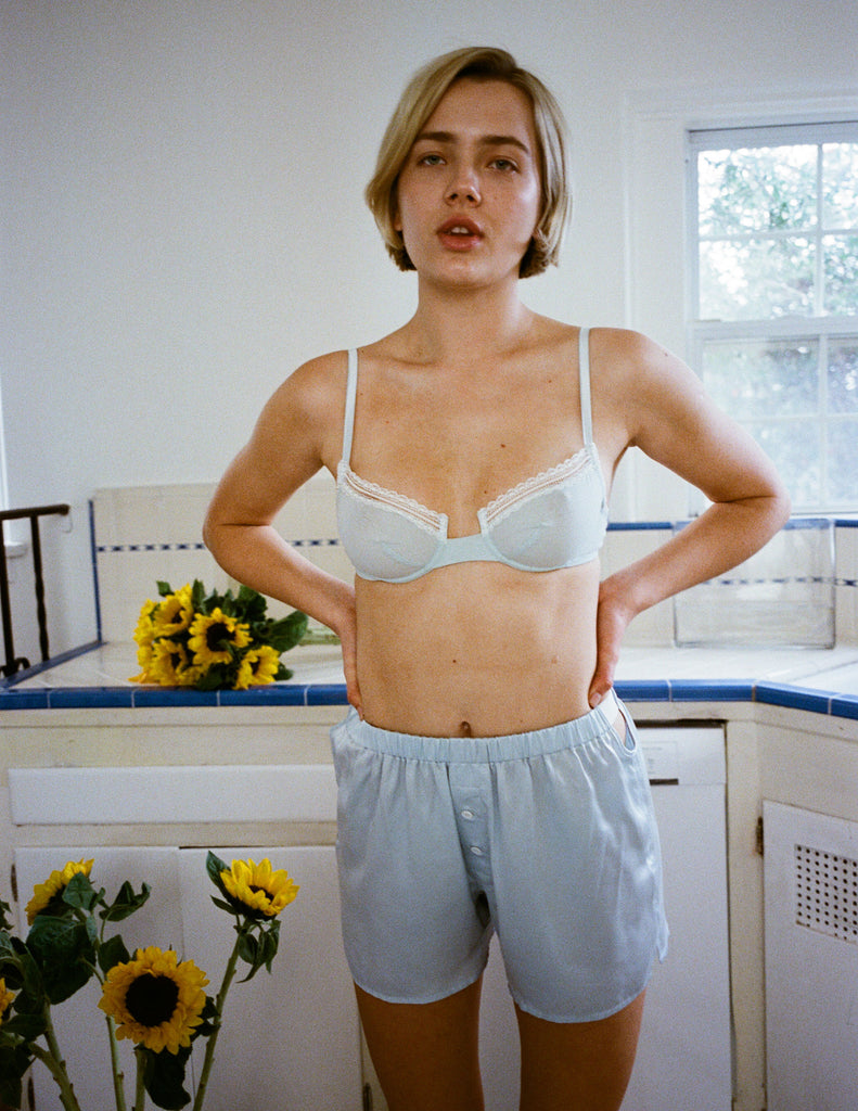 A model wearing the Chloe bra in light blue cotton