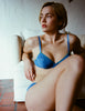 A model wearing the Sofia underwire bra in bright blue cotton