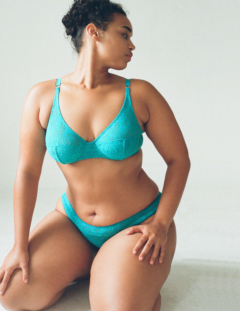 A model wearing the Tris Panty in Turquoise lace