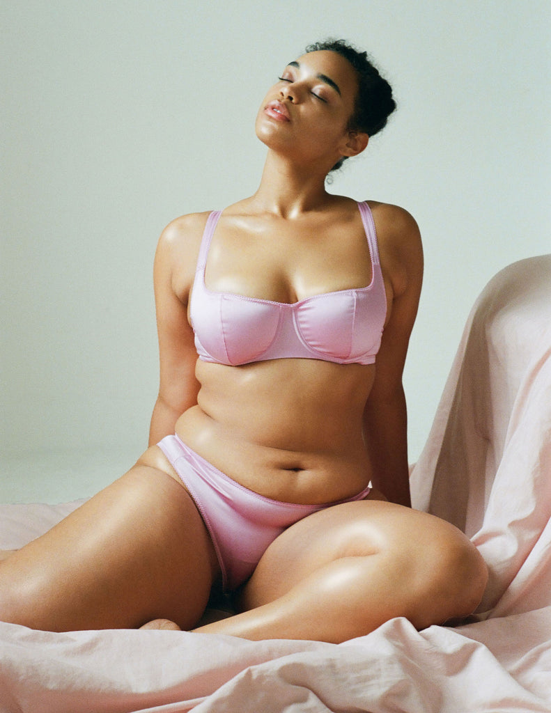 a model wearing the Gita Underwire bra in light pink silk