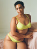 A model wearing the Beau Underwire Bra and Josie Panty in bright yellow cotton.