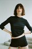 Vanessa wears the long sleeve Sabine Tee and Presley Short in black organic cotton.