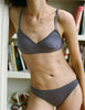 A model wearing Araks Antonia bralette and isabella panty in Violette 