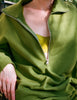 Close up of a model wearing the Araks Vivienne Sweatshirt in the shade Moss