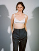 woman wearing white penelope bralette by white wall 
