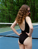 lifestyle back view model image of black one piece swimsuit