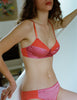 On model editorial image of orange cotton with pink silk bralette and orange cotton with pink silk panty.