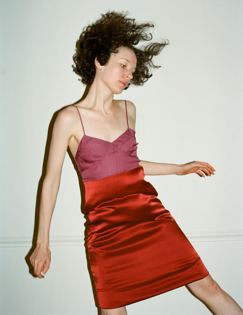 A model wearing the Ingrid Slip in purple and orange silk