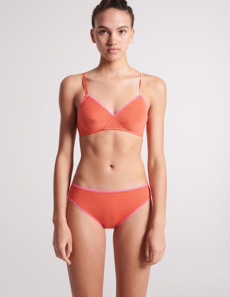 front view of woman in orange bra and panty