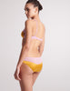 back view of woman in yellow pink silk bra and panty