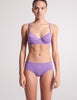 On model image of purple, recycled cotton, underwire bra and purple, hipster, recycled cotton panty