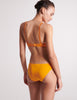 back view of woman in orange bra and panty
