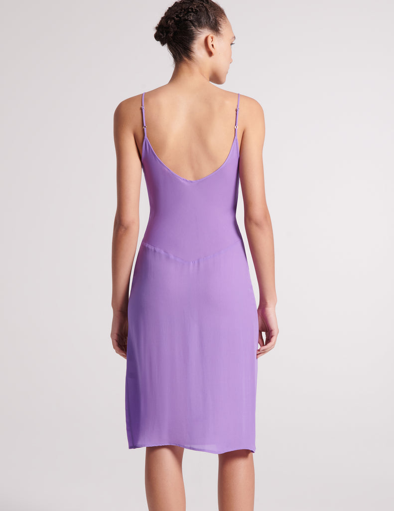 Back view of the silk cadel slip in purple worn on a model.