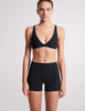 On model image of black swim short and black v-neck swim top