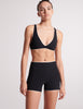 On model image of black bikini top and swim shorts