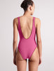 On model image of pink one piece tank bathing suit