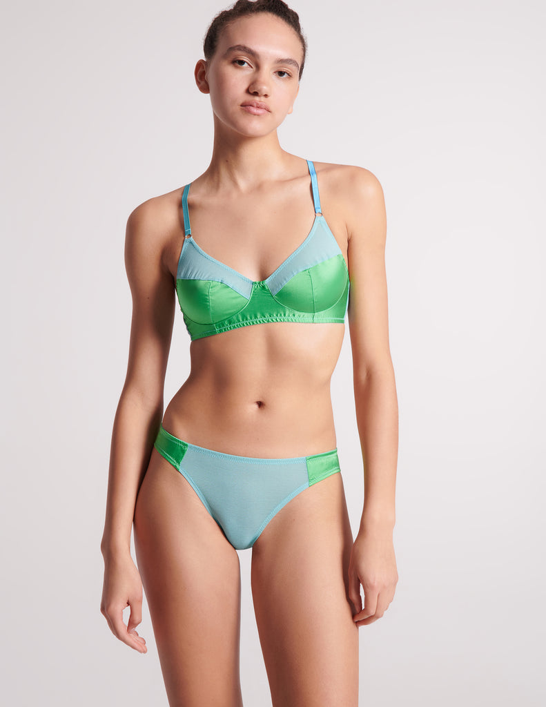 front view of woman in blue and green silk bra